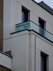 a sign on the side of a building that says penthouse sold