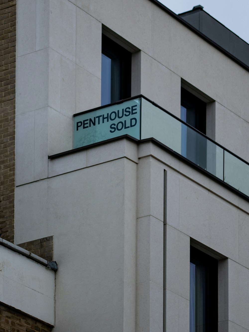 a sign on the side of a building that says penthouse sold