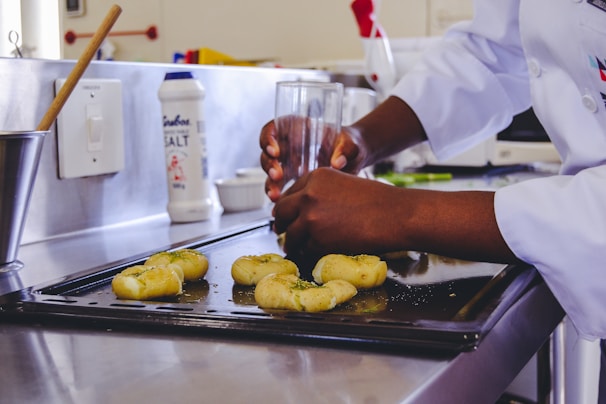 A chef preparing dough for cookies in a bright kitchen.