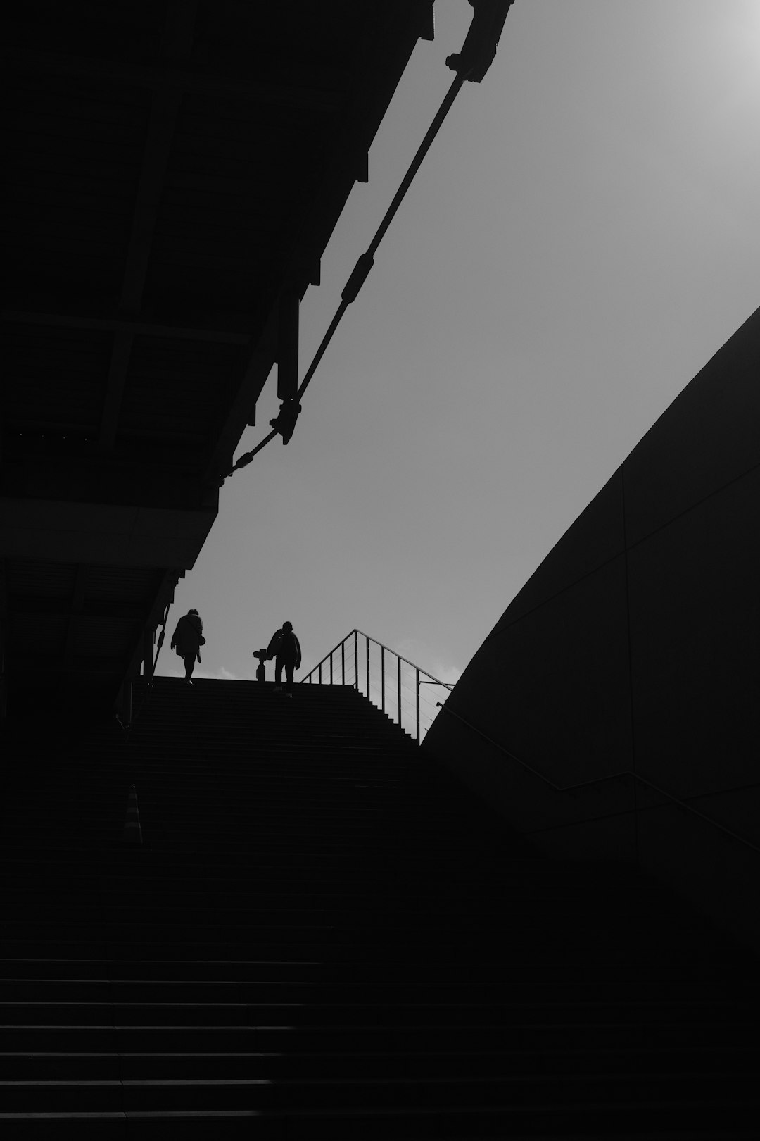 silhouette of people walking on stairs