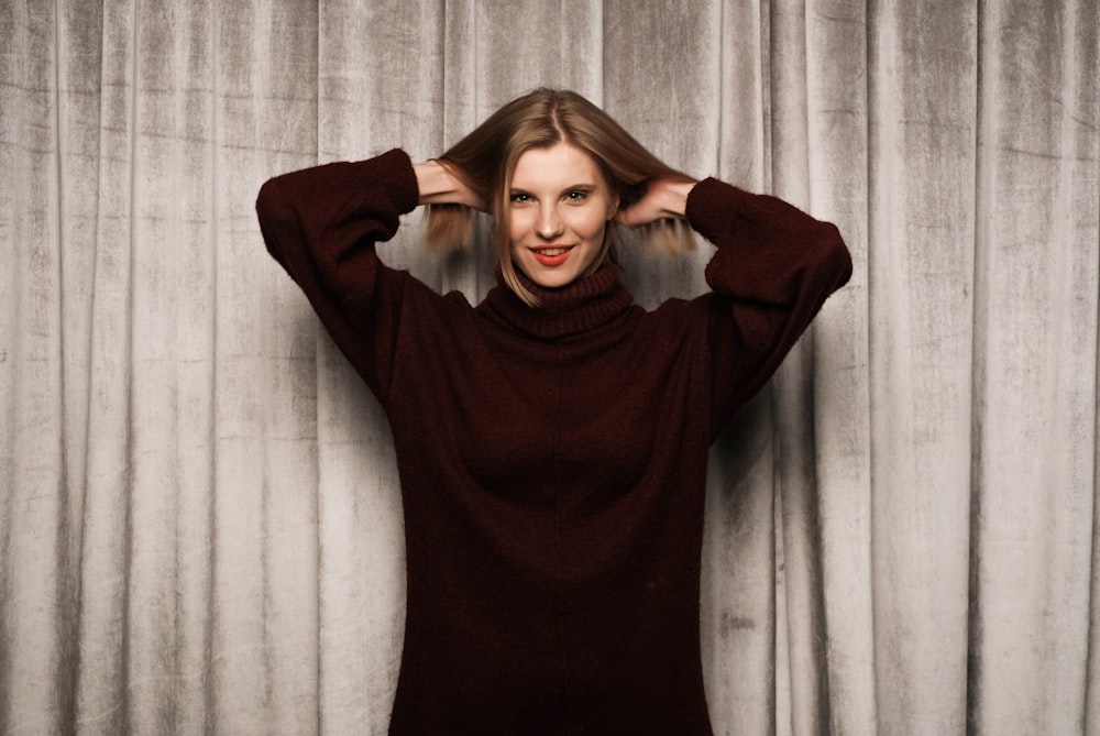 woman in red long sleeve shirt smiling