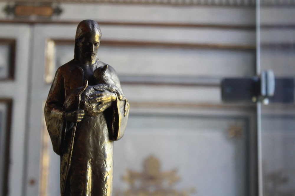 black and gold statue of man