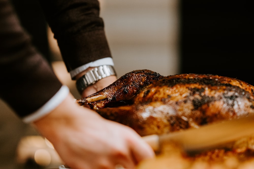 person holding white ceramic plate with grilled meat