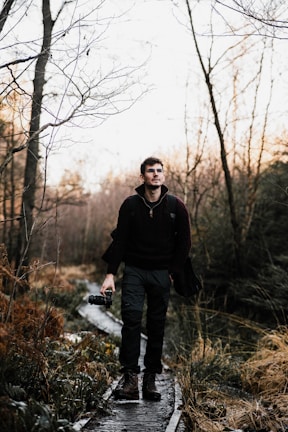 A candid shot of Amira walking along a tree-lined path, the soft light highlighting her excitement.