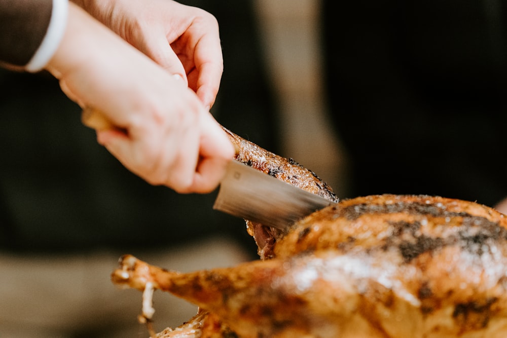 person holding a brown meat