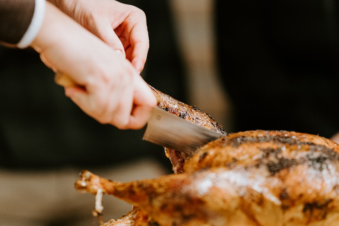 person holding a brown meat,