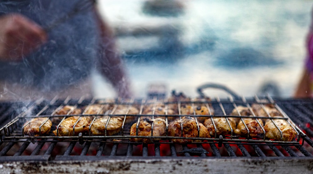 grilled meat on grill under white clouds and blue sky during daytime