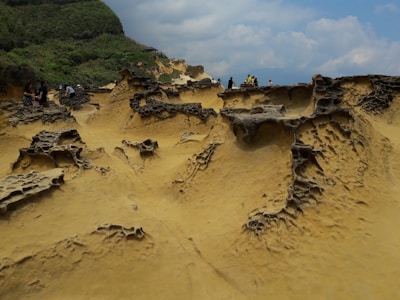 Visitors exploring the unique rock formations and earthy colors of Marafa Hell's Kitchen.