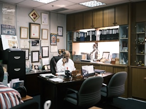 man in white dress shirt sitting on black office rolling chair