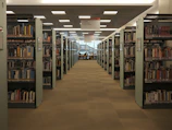 Library corner featuring shelves of medical books and students studying