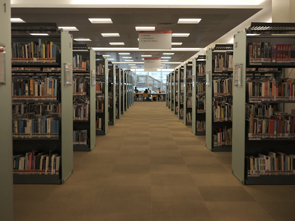 Library corner featuring shelves of medical books and students studying