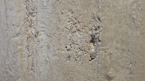 Close-up of a wall showing various damages like holes, cracks, and water stains.