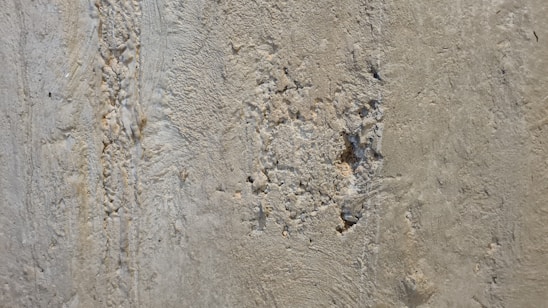 Close-up photo of cracked concrete beam showing detailed structural damage.