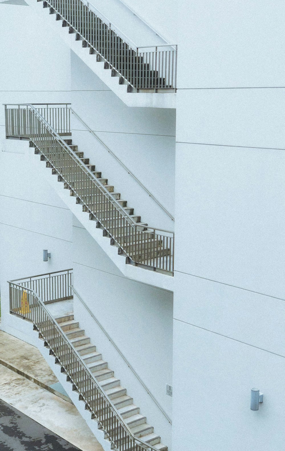 white concrete building with white staircase