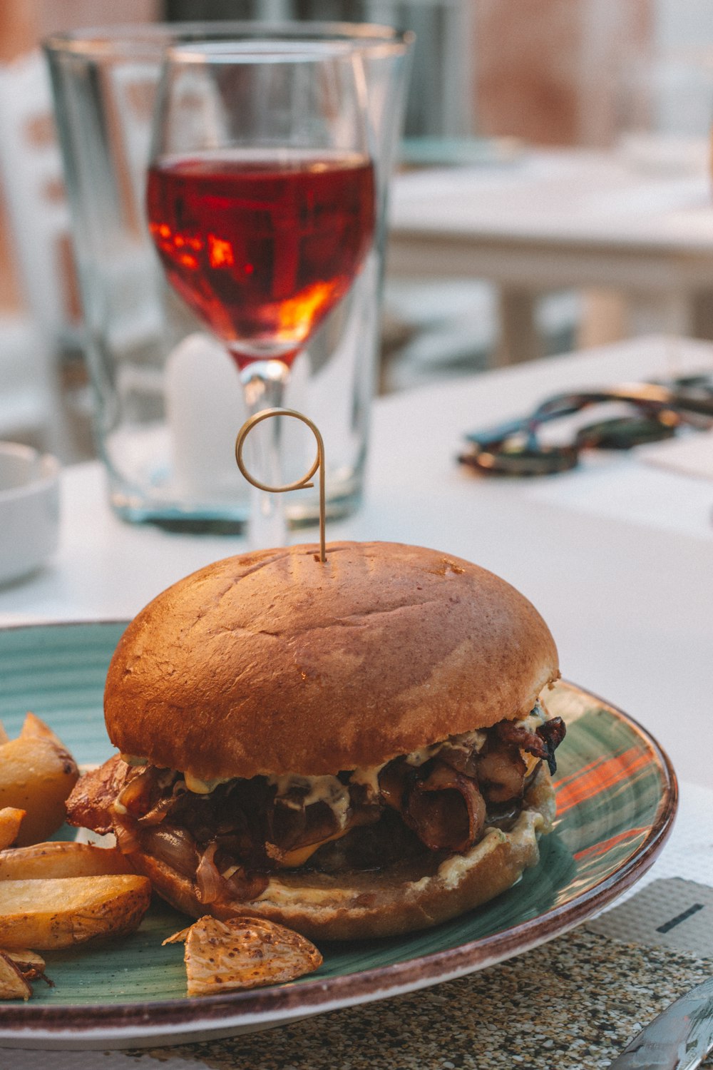 burger with fries on white table