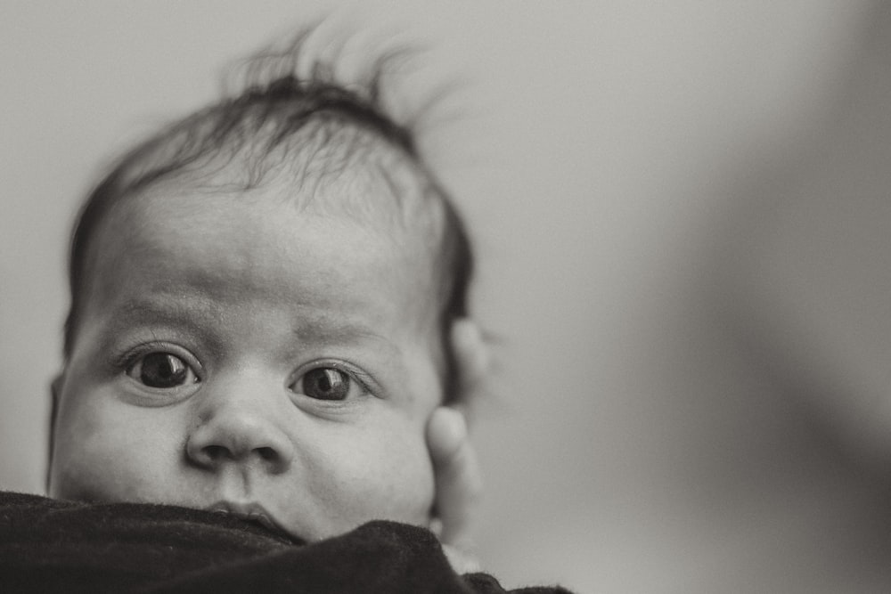 grayscale photo of child in black shirt