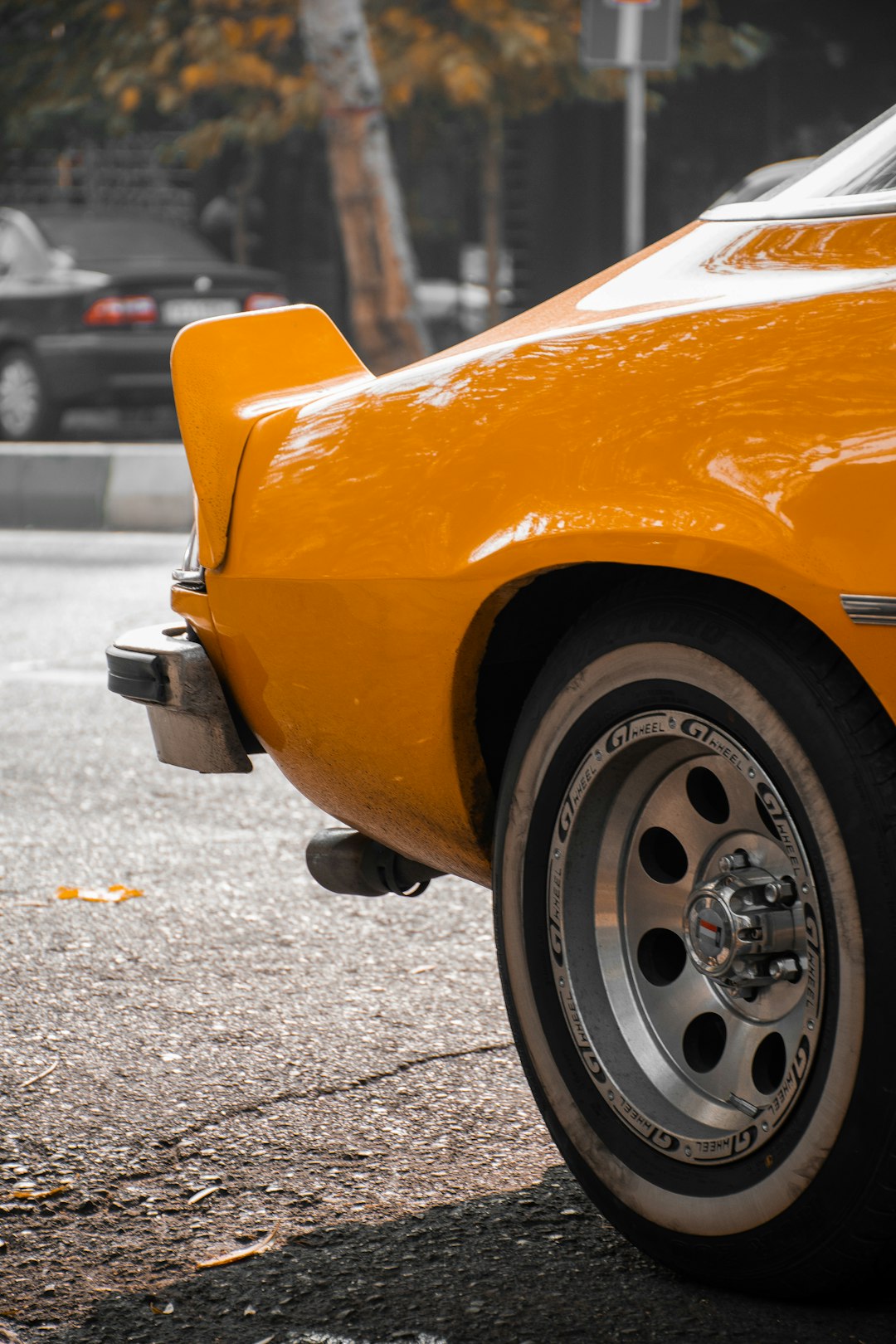 yellow car on gray asphalt road during daytime