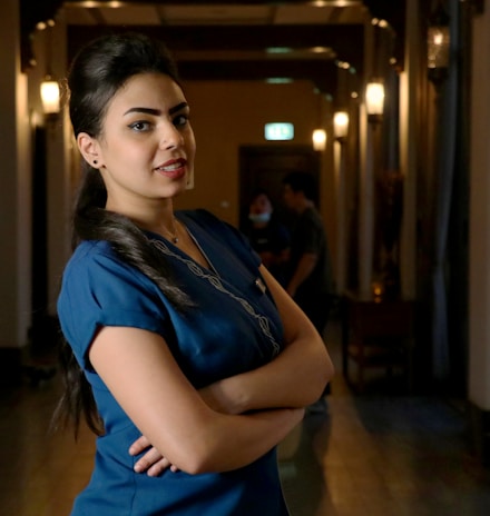 woman in blue shirt standing on hallway