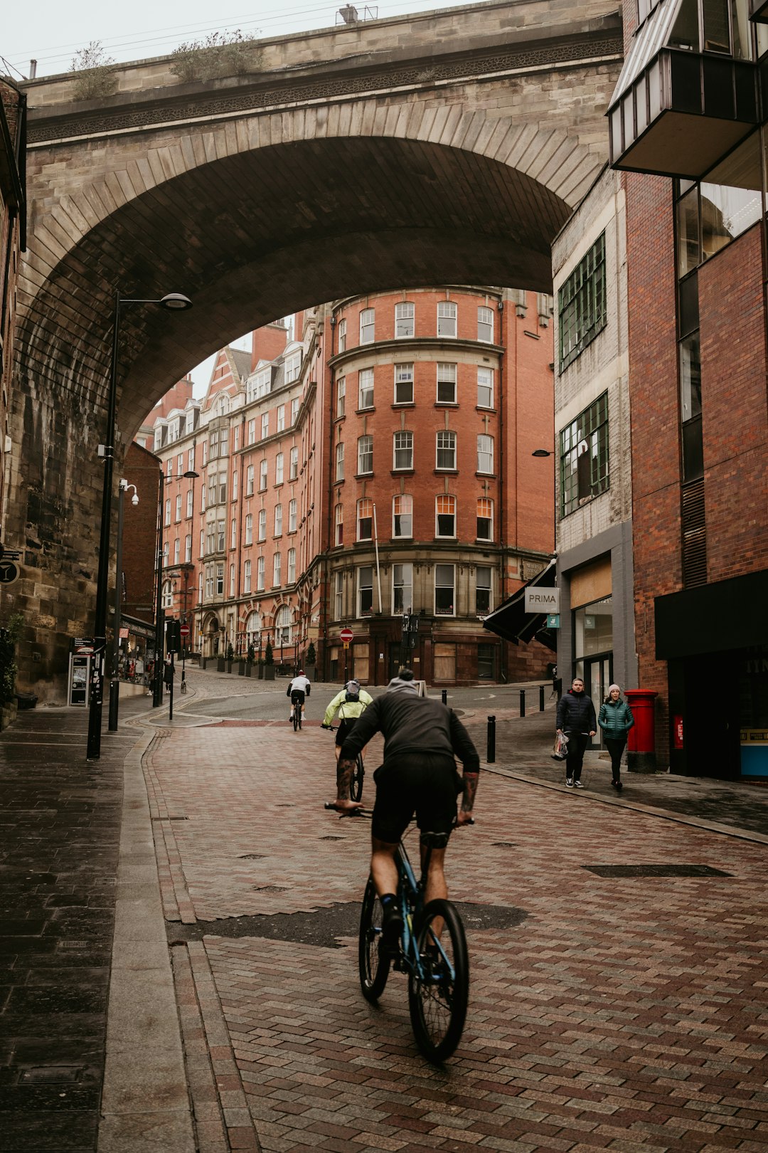 man in black jacket riding bicycle on road during daytime