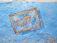 Close-up of a hand-painted fish sign with bright coastal colors and detailed brushwork.
