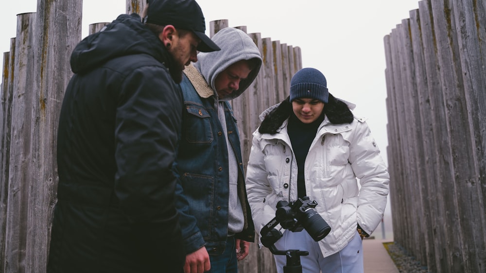 man in black jacket standing beside man in white jacket