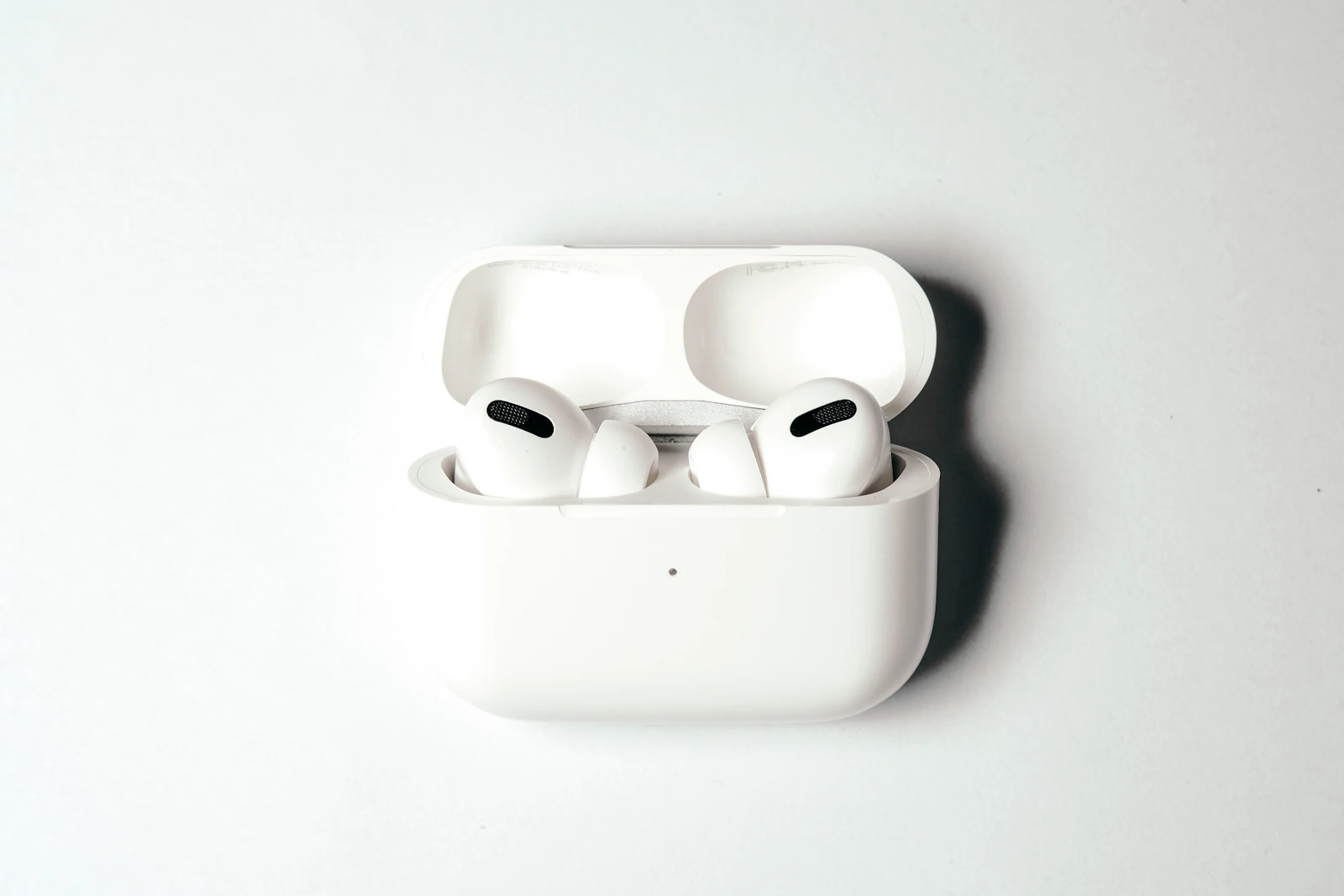 AirPods Pro in open case on white