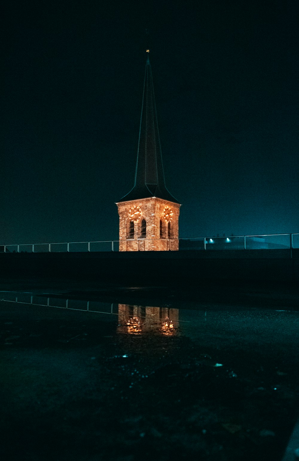 brown concrete building near body of water during night time