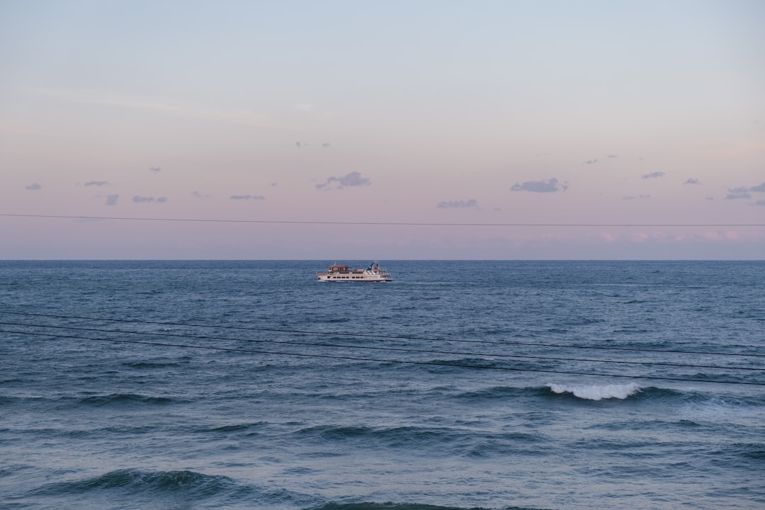 white and black boat on sea during daytime