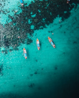aerial view of white and red boat on body of water during daytime
