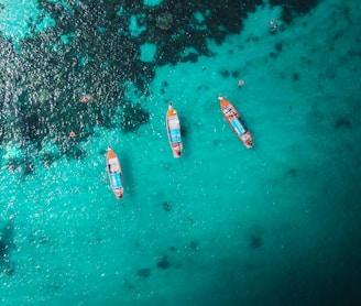 aerial view of white and red boat on body of water during daytime