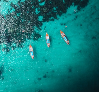 aerial view of white and red boat on body of water during daytime