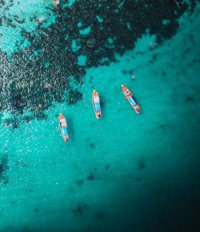 aerial view of white and red boat on body of water during daytime