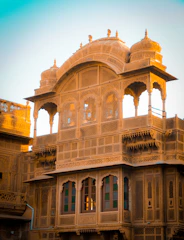 A beautifully restored Omani heritage building bathed in warm sunlight, showcasing intricate traditional architecture.