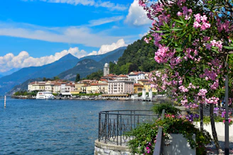 white and brown concrete building near body of water under blue sky during daytime