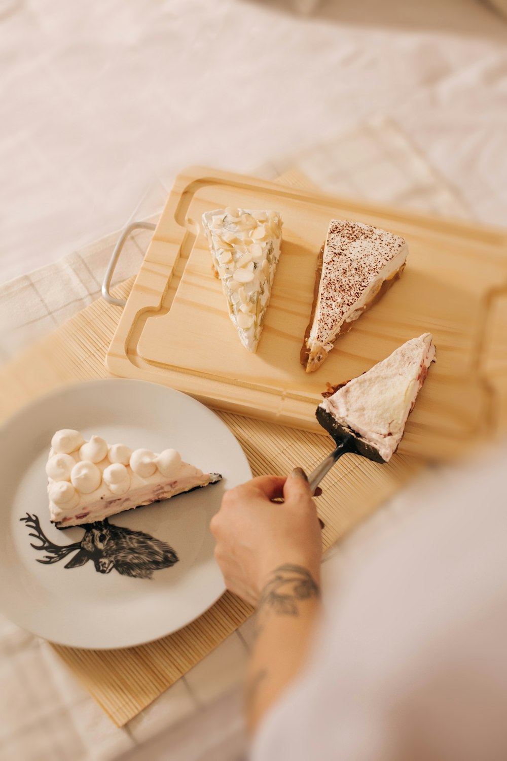 person slicing white cheese on white tray