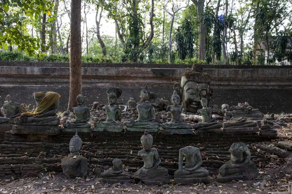 gray concrete statue on forest during daytime