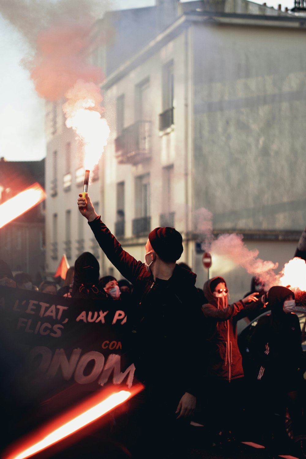 people in black shirts raising hands