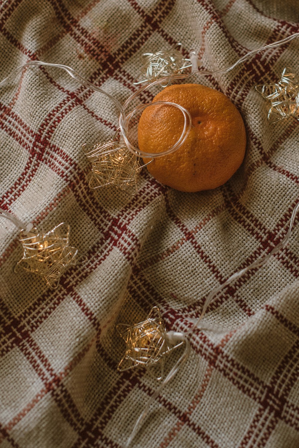 orange fruit on brown and white textile