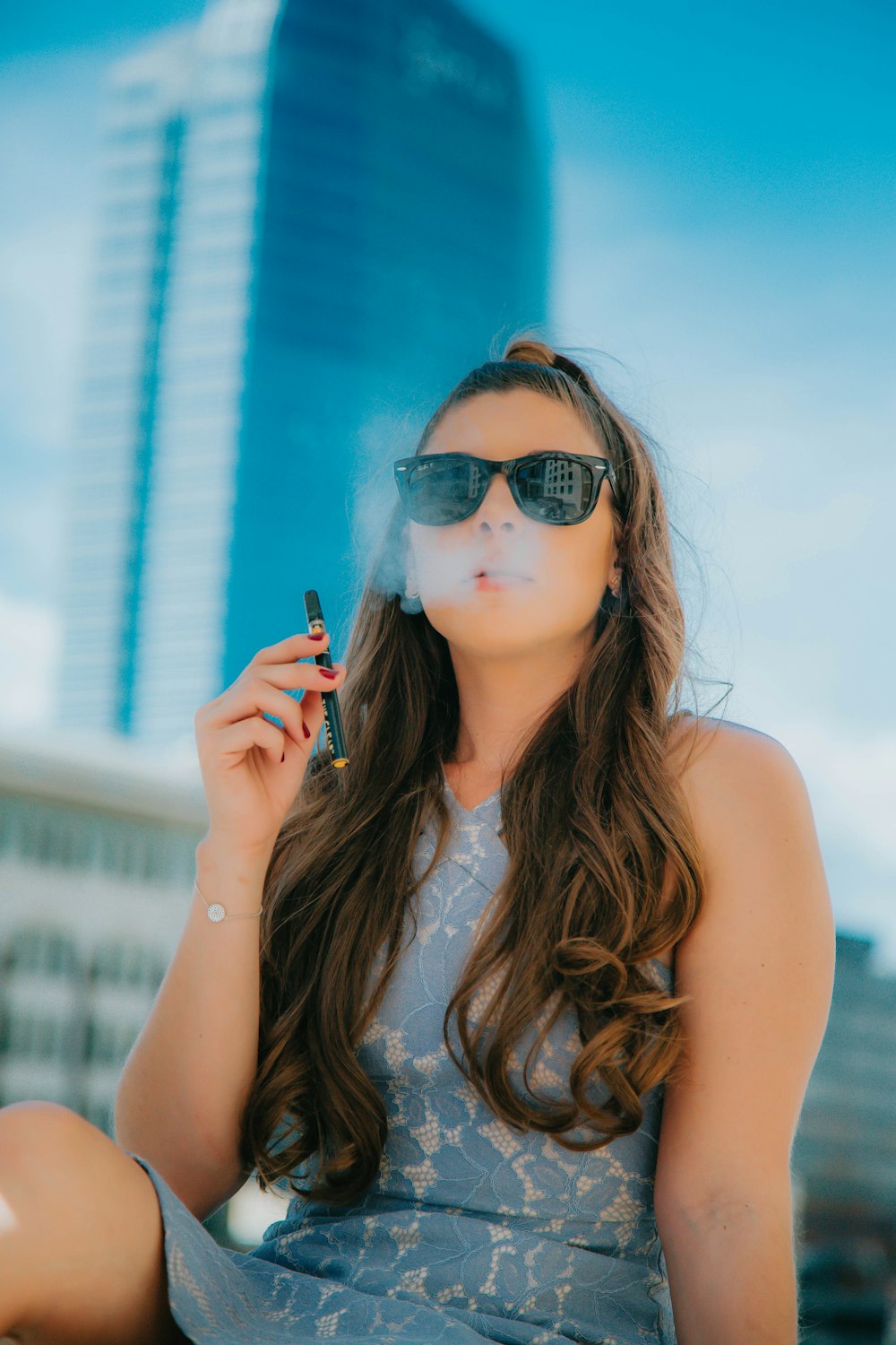 woman in black sunglasses holding smartphone