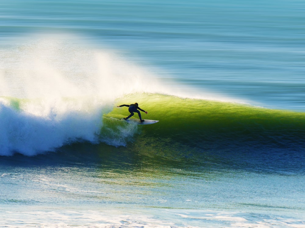 person surfing on sea waves during daytime