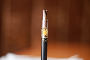 A vibrant close-up of colorful THC vape cartridges glowing softly