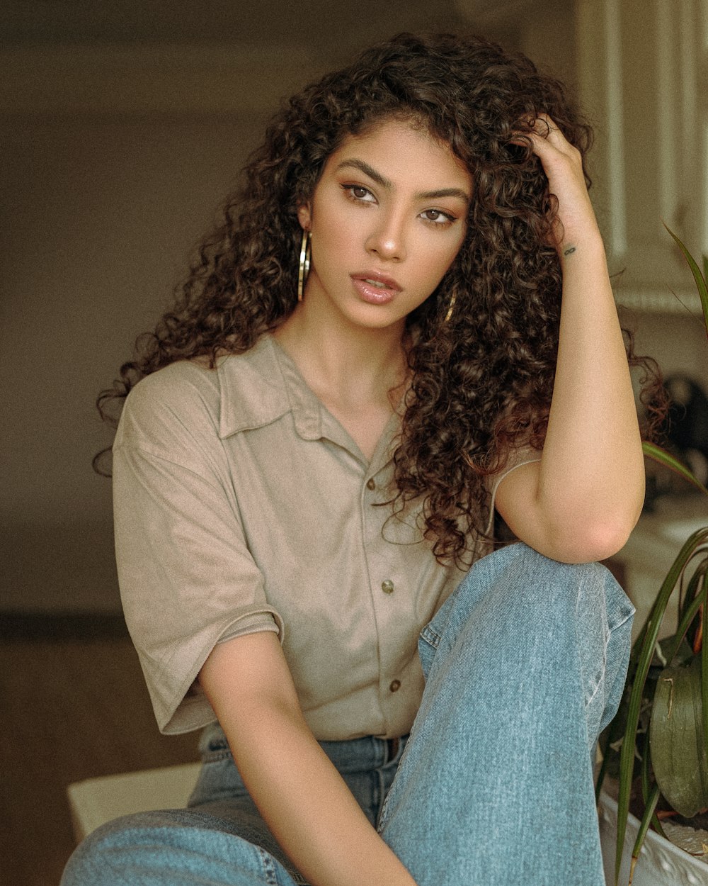 woman in brown button up shirt and blue denim jeans