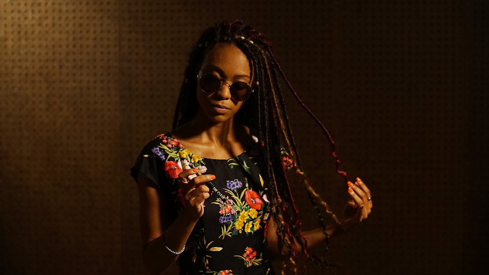 woman in black and red floral dress wearing black sunglasses