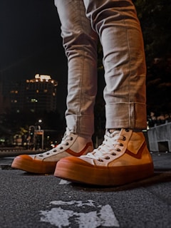 Urban streetwear outfit with sleek sneakers and a minimalist watch under soft city lights.