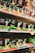 Shelves filled with various types of boxed LED light bulbs are visible, prominently featuring the NOMA brand. The boxes are black with green accents and display images of light bulbs and energy efficiency ratings. Price tags and product information are visible on the shelf edges.