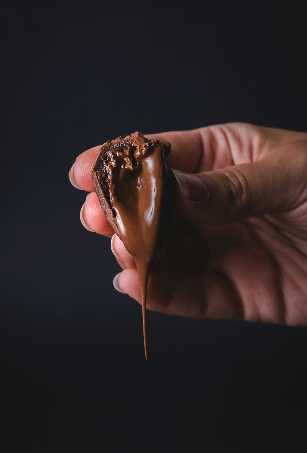 person holding chocolate ice cream