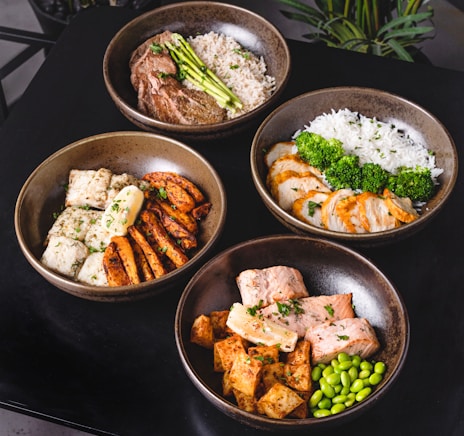 cooked food on black ceramic bowls