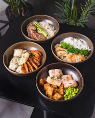 cooked food on black ceramic bowls