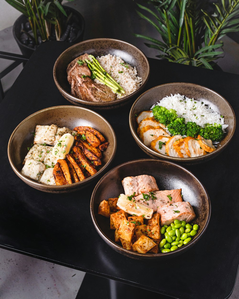 cooked food on black ceramic bowls