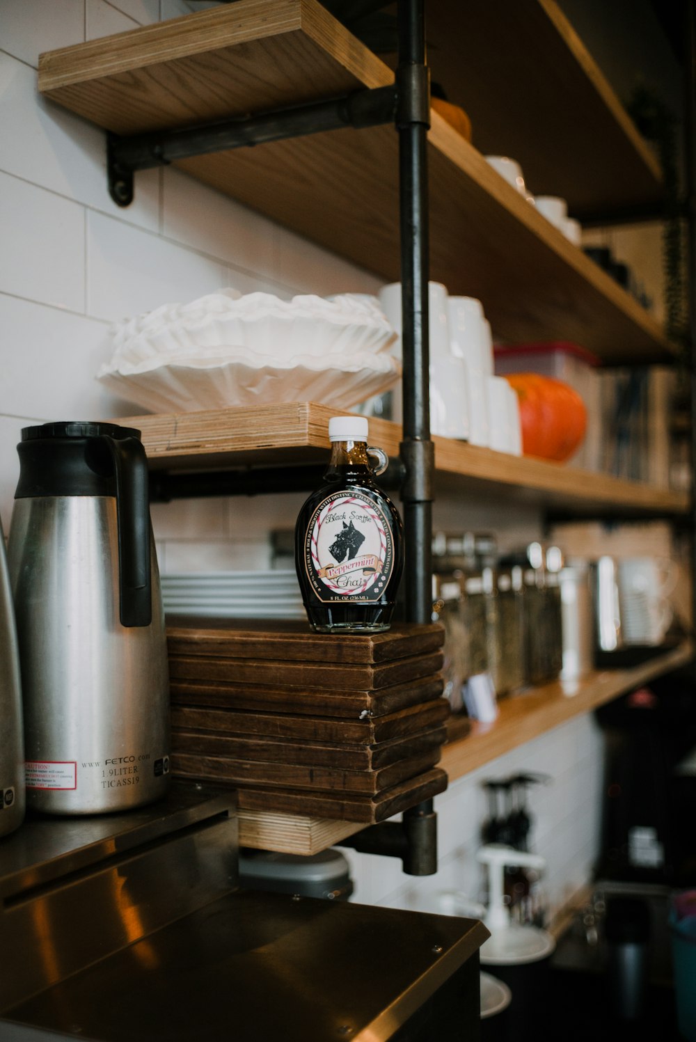 silver and black thermal carafe on brown wooden table